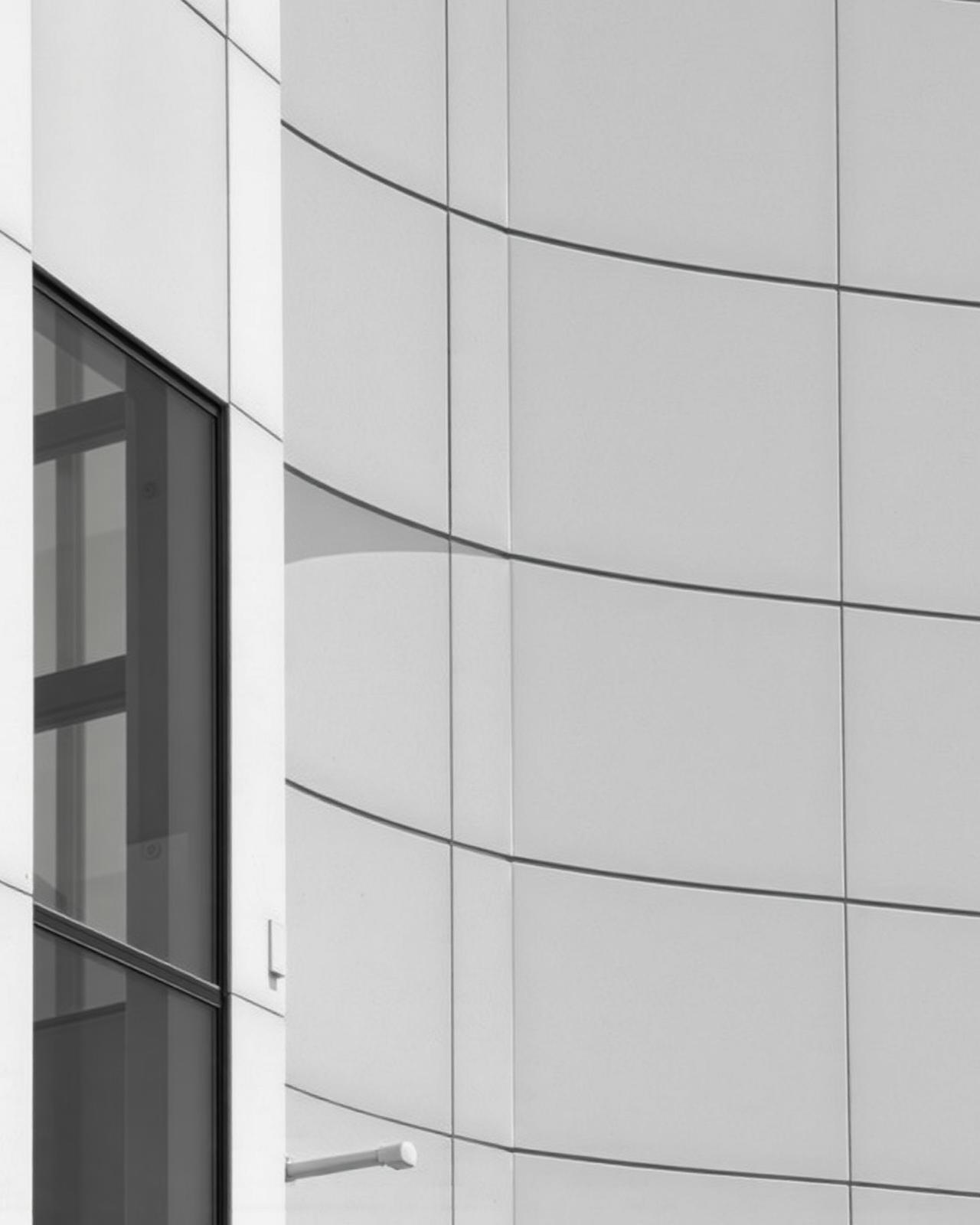 Minimal white curved architectural facade in monochrome